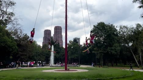 slow-motion-shot-of-the-traditional-voladores-de-papantla-in-Chapultepec,-mexico-city