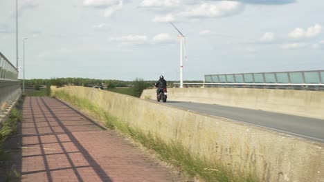Motorcycle-driving-fast-over-a-bridge-in-Belgium