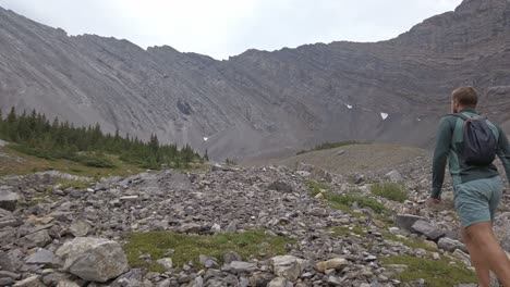 Hiker-walking-up-mountain-followed-tilt-Rockies-Kananaskis-Alberta-Canada