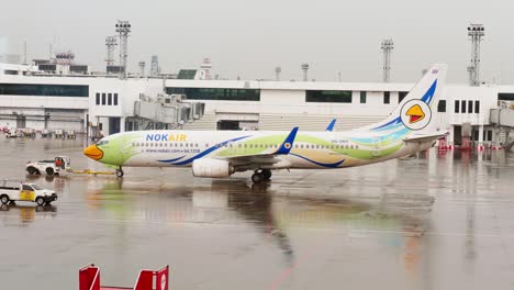 Nok-Air's-Boeing-737-is-being-pushed-back-and-started-up-at-Donmuang-Airport,-Bangkok,-Thailand