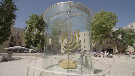 JERUSALEM,-ISRAEL---September-2,-2022:-the-Golden-Menorah,-a-Jewish-monument-protected-under-bulletproof-glass,-at-the-Western-Wall-square-in-Jerusalem