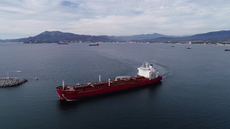 Aerial-view-around-a-empty-tanker,-moving-towards-the-Manzanillo-seaport,-in-Mexico---circling,-drone-shot
