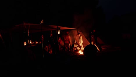Knights-of-the-Middle-Ages-resting-in-a-camp-tent-at-night-with-a-campfire-for-warmth