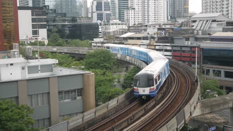View-of-BTS-Sky-train-while-passing-through-the-Bangkok-City-in-sunshine-daytime-with-unclear-sky