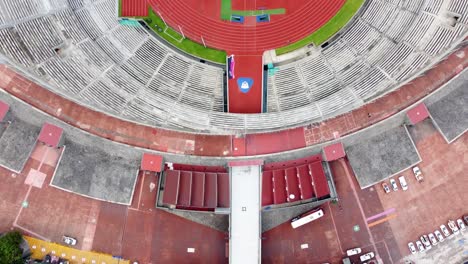 Top-Down-Shot-Across-the-Beautiful-University-Olympic-Stadium-of-the-UNAM,-with-a-View-of-the-Bleachers,-the-Field-and-the-Running-Track-in-Mexico-City