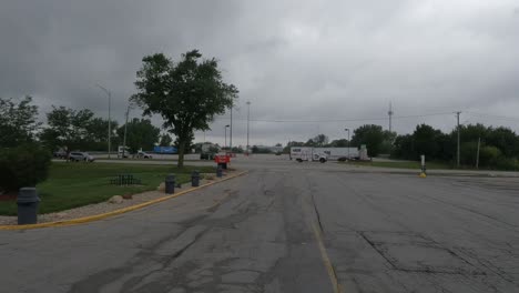 Parked-cars-and-trucks-driving-away-from-the-truck-stop-in-Monee,-Illinois-Chicago
