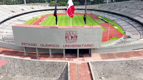 Aerial-Shot-Over-the-Entrance-and-Through-the-Beautiful-Green-Field-of-the-University-Olympic-Stadium-of-the-UNAM-in-Mexico-City