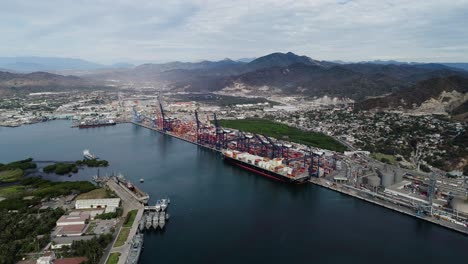 Aerial-view-of-a-large-bulk-carrier-docked-at-the-Port-of-Manzanillo,-in-cloudy-Mexico