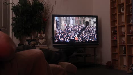 Household-watching-Her-Majesty-Queen-Elizabeth-ceremonial-funeral-service-broadcast-on-British-television-at-home