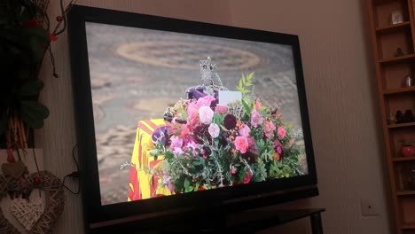 Patriotic-household-watching-Her-Majesty-Queen-Elizabeth-ceremonial-funeral-service-broadcast-on-British-television-at-home