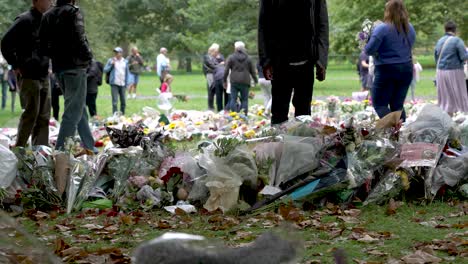 People-Walking-Past-Floral-Tributes-For-Death-of-Queen-Elizabeth-II-In-Green-Park