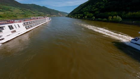 Amazing-FPV-Shot-Of-Two-Ferry-Boats-Sailing-Opposite-Sides-In-Danube-River,-Austria
