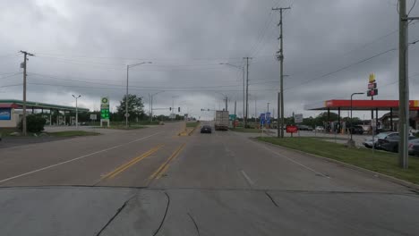 POV-shot-driving-on-the-road-next-to-a-gas-station-in-Monee,-Illinois-