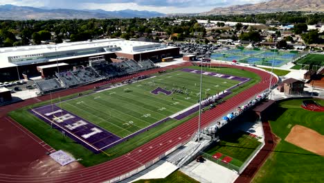 Lehi,-Utah-High-School-football-stadium-during-a-game---orbiting-aerial-motion-time-lapse