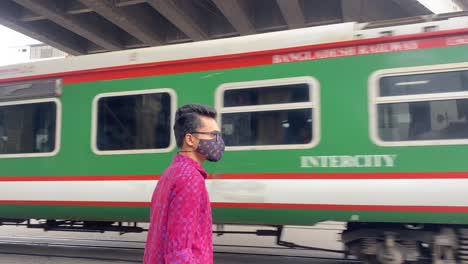 Junger-Reisender,-Der-Während-Einer-Pandemie-In-Bangladesch-Einen-Leeren-Zug-Beobachtet,-Der-Vorbeifährt