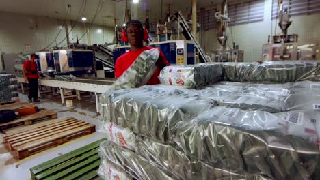 Loading-packaged-coffee-beans-on-a-shipping-pallet-at-the-factory