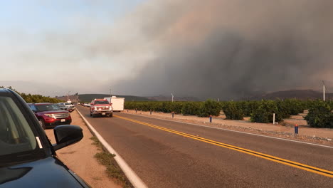 Battalion-Chief's-vehicle-passing-the-camera-with-a-wildfire-in-the-background