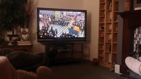 Family-watching-her-Majesty-Queen-Elizabeth-ceremonial-funeral-service-broadcast-on-British-television-at-home