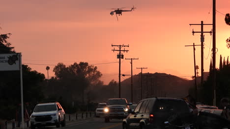 Helicopter-flying-at-dawn-over-California-wildfire