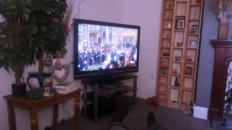 Family-household-watching-Her-Majesty-Queen-Elizabeth-ceremonial-funeral-service-broadcast-on-British-television-at-home