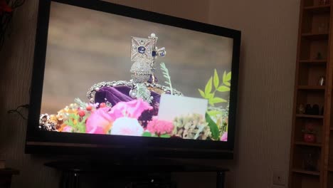 Household-watching-Her-Majesty-Queen-Elizabeth-ceremonial-funeral-service-broadcasting-on-British-television-at-home