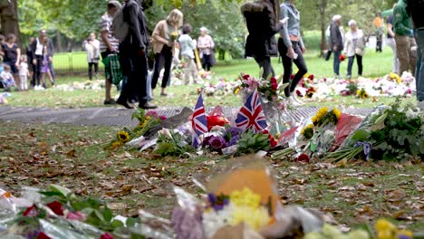 Small-Union-Jack-Flags-In-The-Ground-Beside-Floral-Tributes-For-Death-of-Queen-Elizabeth-II-In-Green-Park