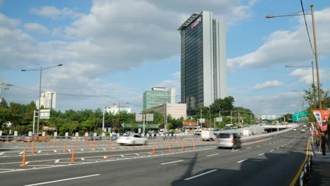 LG-Electronics-Seocho-Research-and-Development-Campus-Building-on-a-cloudy-day,-Yangjae-daero-road-busy-many-cars-traffic-time-lapse---static