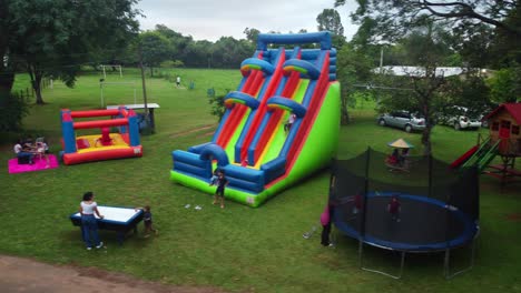 Happy-children-playing-on-a-trampoline-and-some-bouncy-castles-at-a-birthday-party