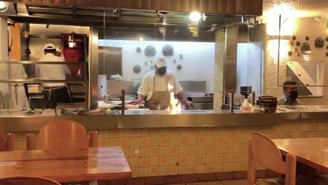 slow-motion-shot-of-waiter-preparing-taco-plates-in-mexico-city