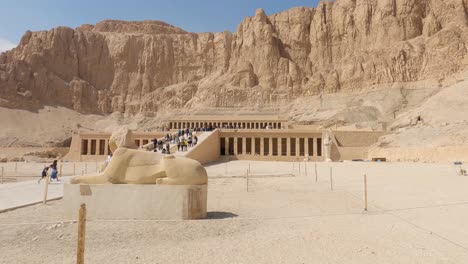 Egyptian-Sculpture-At-The-Entrance-To-The-Funerary-Temple-Of-Hatshepsut-With-Tourists