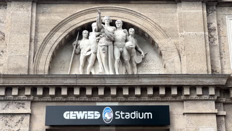 Close-up-Gewiss-Stadium-entrance-sign-and-historic-building-statue