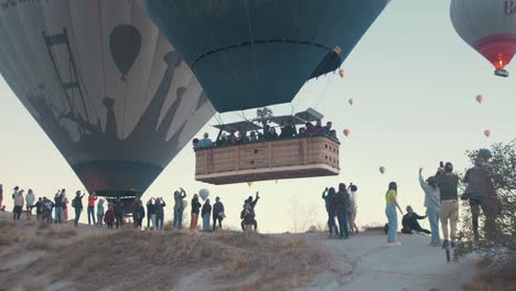 Hot-air-balloon-flys-low-over-onlookers-at-Cappadocia
