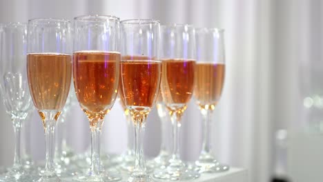 Group-Glasses-Of-Sparkling-Champaign-With-Bubbles-On-White-Table