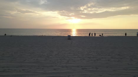 Sunrise-Above-Atlantic-Ocean,-Drone-Shot-of-People-Walking-on-Sandy-Beach-of-Boca-Raton,-Florida-USA,-Sliding-Dolly