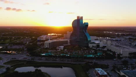 Aerial-view-towards-the-Seminole-Hard-Rock-Hotel,-during-sunset---approaching,-drone-shot