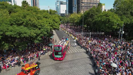 Aerial-view-around-a-bus-full-of-people-celebrating-the-day-of-the-dead,-in-sunny-Mexico-city