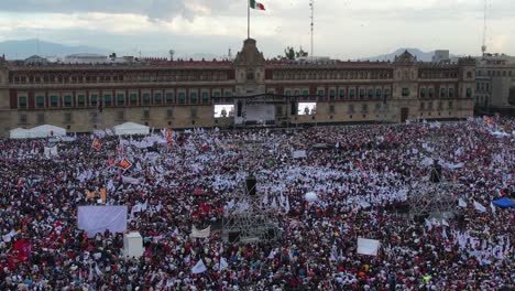President-speaking-in-front-of-the-National-Palace-at-Zocalo-Square,-in-Mexico-city---Aerial-view