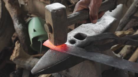 Blacksmith-Strikes-Hot-Metal-with-Heavy-Hammer-on-Anvil-to-Shape-it