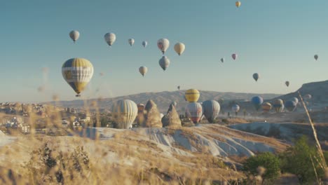 Cappadocia-Sunrise-Hot-Air-Balloons-fill-the-sky,-Slider-Shot