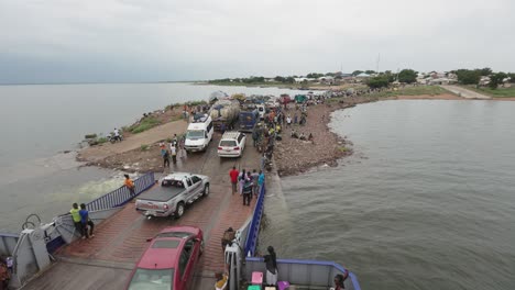 Passengers-and-Vehicles-Disembark-Cargo-Barge-on-River-Afram-High-Angle-Shot