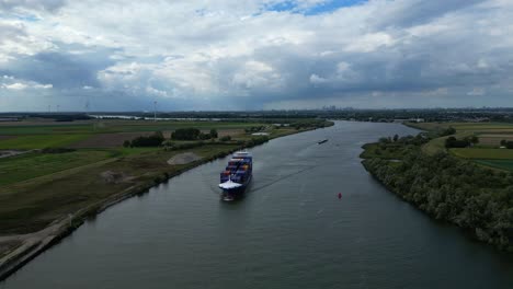 Aerial-View-Of-BG-Onyx-Cargo-Container-Ship-Approaching-Along-Oude-Maas-Through-Zwijndrecht-In-The-Background