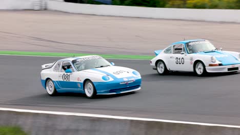 Two-Vintage-Porsche-race-cars-speed-down-race-track-during-Mosport-Drive-Fest
