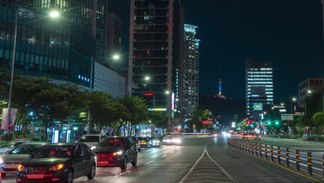 Seoul-busy-night-road-traffic-timelapse-in-Yongsan-gu-district-near-Yongsan-and-Sinyoungsan-subway-station,-view-of-Namsan-tower-and-city-skyline---panoramic-panning