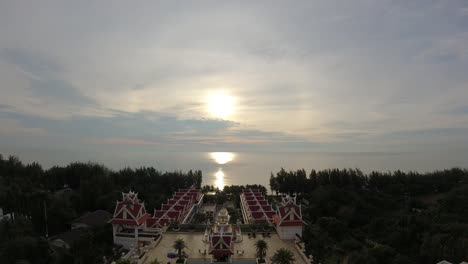 Aerial-time-lapse-of-a-dramatic-golden-sunrise-overlooking-a-hotel-resort-and-ocean-view-of-the-Gulf-of-Thailand-in-Cha-Am-Beach,-Thailand