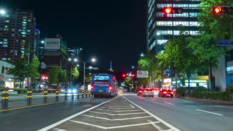 Night-crowded-city-street-in-center-with-transportation-scene-time-lapse-in-Seoul-Yongsan-gu-district-with-a-view-of-Namsan-tower-or-N-Seoul-Tower