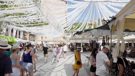 People-going-throw-the-market-in-Pollença,-town-at-mallorca-island-in-the-balearic-sea
