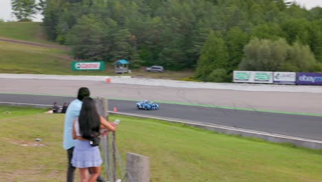 Fast-Mustang-sports-car-with-racing-stripes-speeds-through-a-turn-at-Mosport-speedway-during-Drive-Fest
