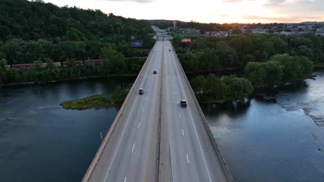 Aerial-above-highway-bridge-at-sunset