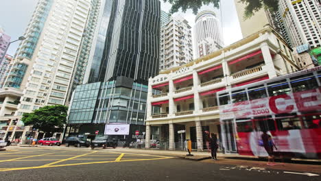 Motion-blur-Timelapse-of-street-traffic-and-pedestrian-movement-at-Woo-Cheong-Pawn-Shop-in-Wan-Chai,-Hong-Kong