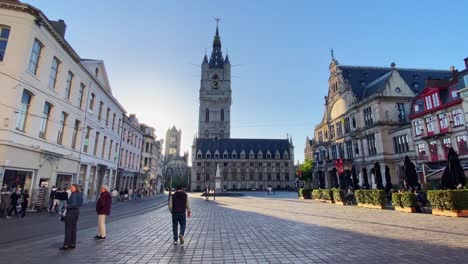 Belfort-van-Gent---Tourists-Walking-Near-The-Belfry-of-Ghent-At-Golden-Hour-In-Ghent,-Belgium
